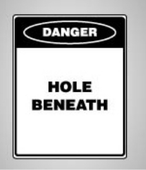 Figure 5 shows an example of the type of danger sign to be affixed to a hole cover.