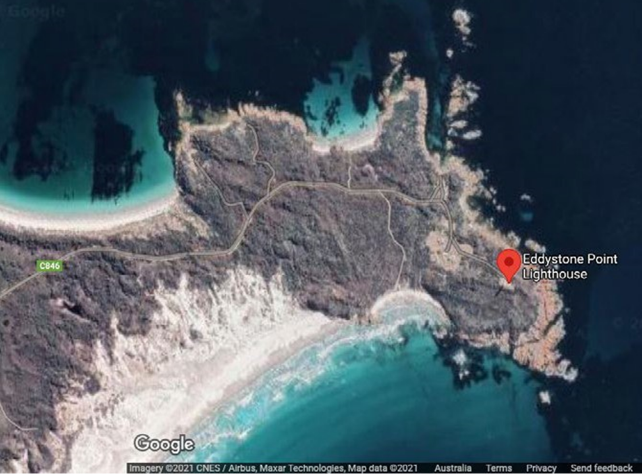 Satellite map showing Eddystone Point, a prominent headland surround by blue waters and beaches. Location marker identifies location of lighthouse on tip. Google Maps