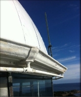 Photograph showing corner of white lantern roof done, antenna can be seen fixed vertically from roof gutter.