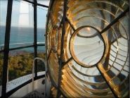 Photograph showing outside of lighthouse lens. Prisms are arranged in concentric circles to make an 'eye' for the light. 