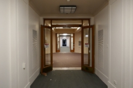 A corridor with two glass doorways.