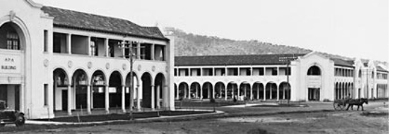 Two large buildings with a horse and cart visible.