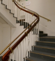 A staircase with a timber handrail.