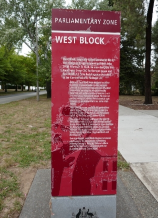 An interpretive sign titled 'Parliamentary Zone West Block'.  The sign is between a road and a footpath.