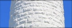 Photograph showing section of white, stone lighthouse tower.