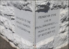 Photograph showing plaque embedded in white, rough-hewn stone wall which reads "Dedicated to the world's mariners 13th December 1895. Foundation Stone laid by Hon. Sir John Forrest KCMC
Premier of the Colony 13th December 1895"
