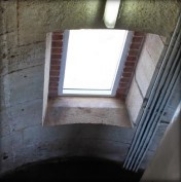 Photograph showing window set into brick opening.