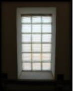 Photograph showing large window opening.