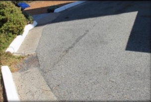 Photograph showing paving and concrete kerb. 