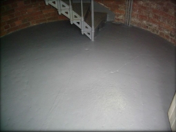 Photograph showing rounded grey floor of lighthouse tower.  