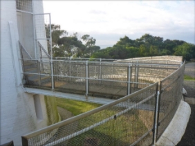 Photograph showing bridge access leading to upper lighthouse entry door.