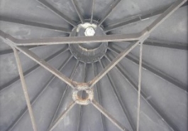 Photograph showing underside of roof, metal ribs and top ring are exposed.