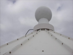 Photograph showing round ventilator fitted to top of white roof.