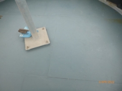 Photograph showing painted lantern floor. A metal stand is bolted to floor. 