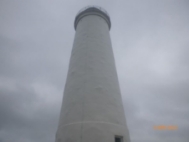 Photograph showing white, rendered lighthouse tower.