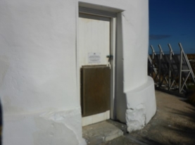 Photograph showing timber door fitted to base of lighthouse tower. 