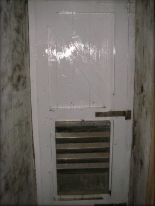 Photograph showing white timber door. 