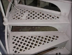 Photograph showing cast iron lattice stair treads.