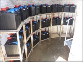 Photograph showing curved racks holding battery packs. 