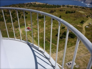 Photograph showing curved balcony balustrade fitted to outer edge of balcony floor. A red helicopter can be seen on the ground below. 