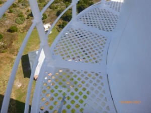 Photograph showing curved lattice balcony with balustrades fitted to outer edge of floor. 