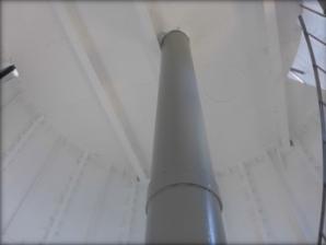 Photograph showing grey weight tube fitted to underside of a round floor. 