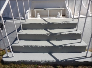 Photograph showing four steps leading to base of tower door. 