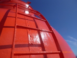 Photograph showing curved red dome ladder fitted to lighthouse dome.