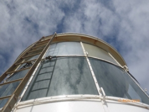 Photograph showing lantern house with curved glazing panes, and a ladder fitted to external side.