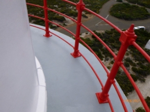 Photograph showing curved balcony floor with curved red handrails fitted to outer edge of balcony floor.