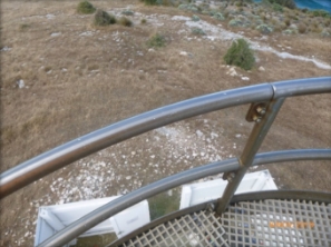 Photograph showing fibreglass mesh balcony with stainless steel railings fitted to outer edge of balcony flooring. 