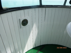 Photograph showing inside of curved lantern room, with an internal lining made of vertical timber boards. 