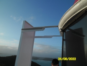 Photograph showing steel bracket attached to light screen panel fitted to roof gutter.