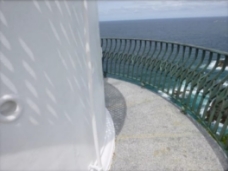 Photograph showing curved granite balcony floor with gunmetal railing fitted to outer edge. 